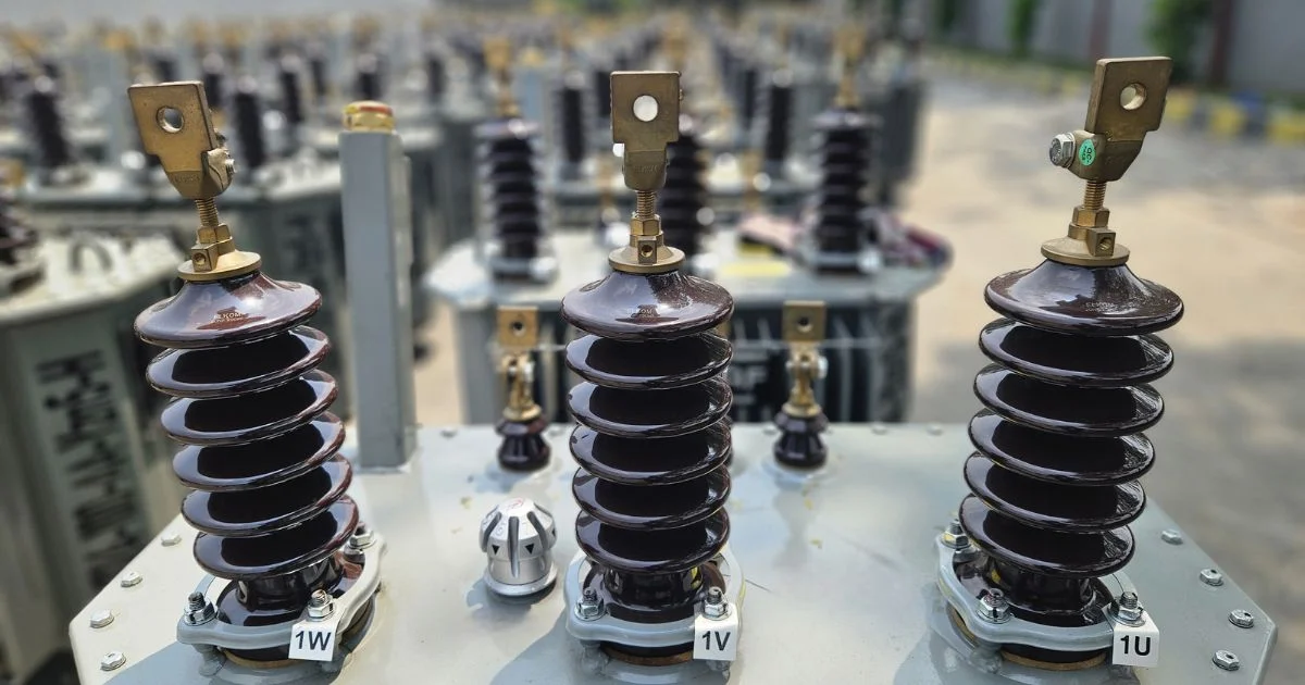 Close-up of transformer bushings with insulators
